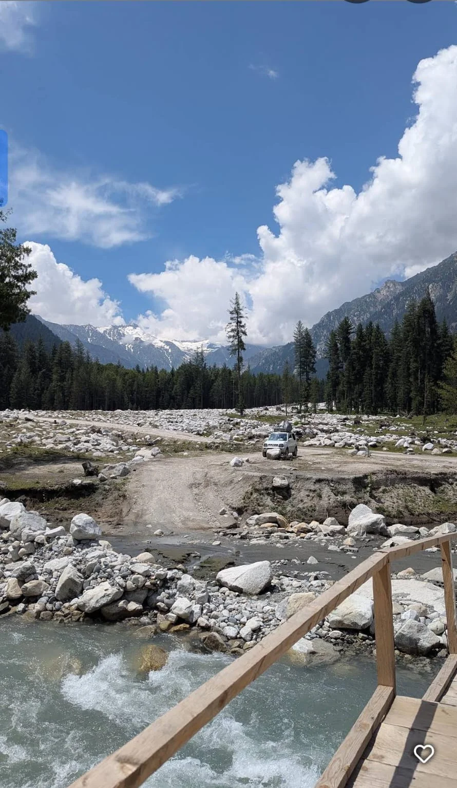 The river flowing through the rocky Kumrat Valley beneath blue skies